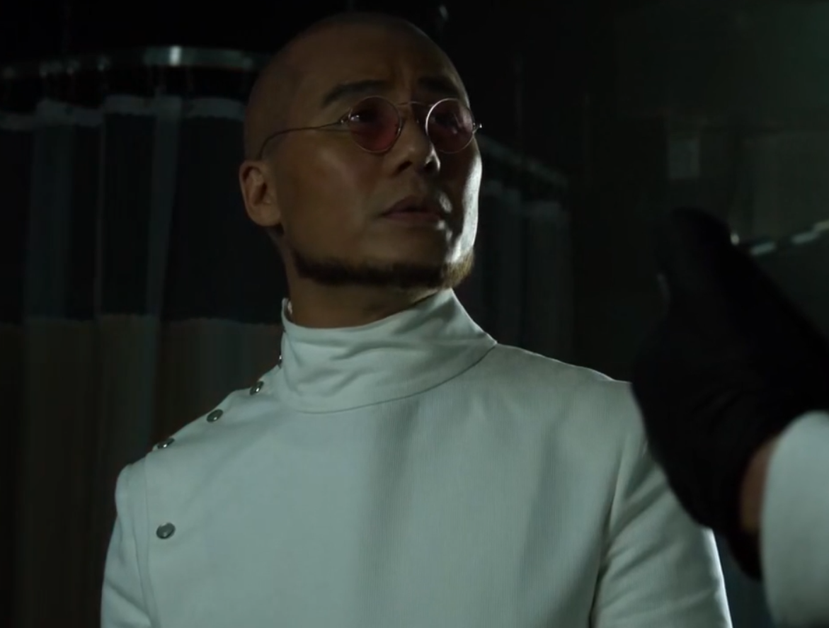 BD Wong as Hugo Strange in Gotham. He's wearing his classic, Arkhamverse-style labcoat.