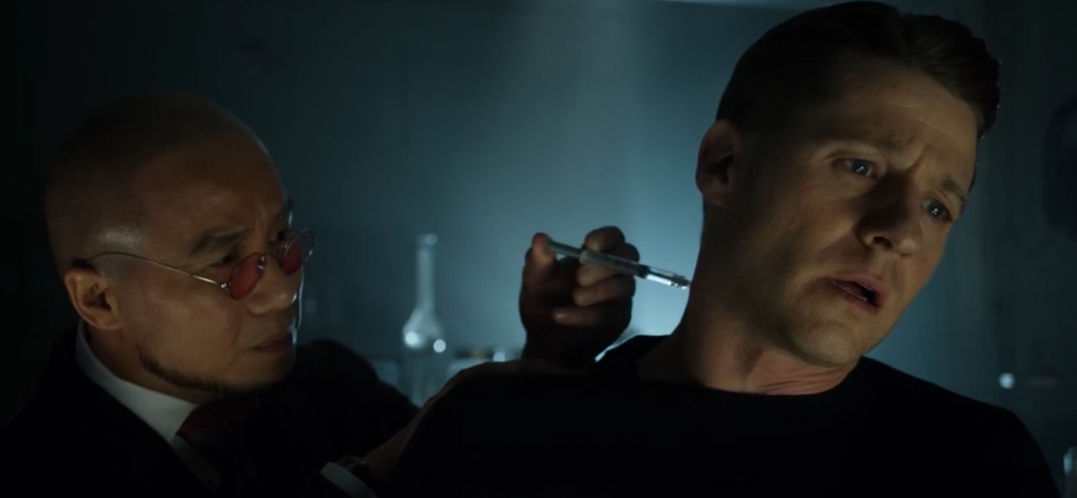 Hugo injects a captive Jim Gordon in the neck with a truth serum.