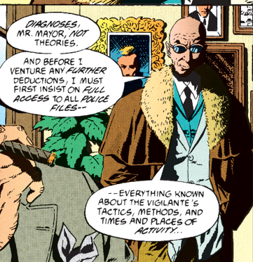 Hugo has a 3-piece suit but with a mismatched waistcoat, underneath a Sherlock Holmes style brown coat with a huge fur trim around the round lapel.